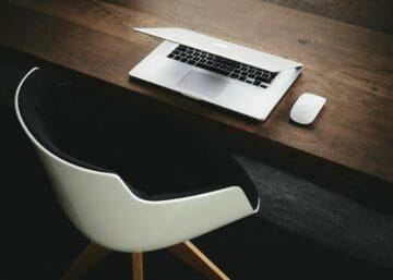 Apple MacBook beside computer mouse on table