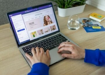 a person typing on a laptop on a table