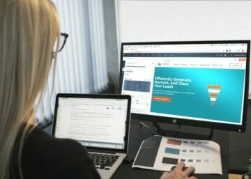 woman sitting in front of turned-on computer monitor