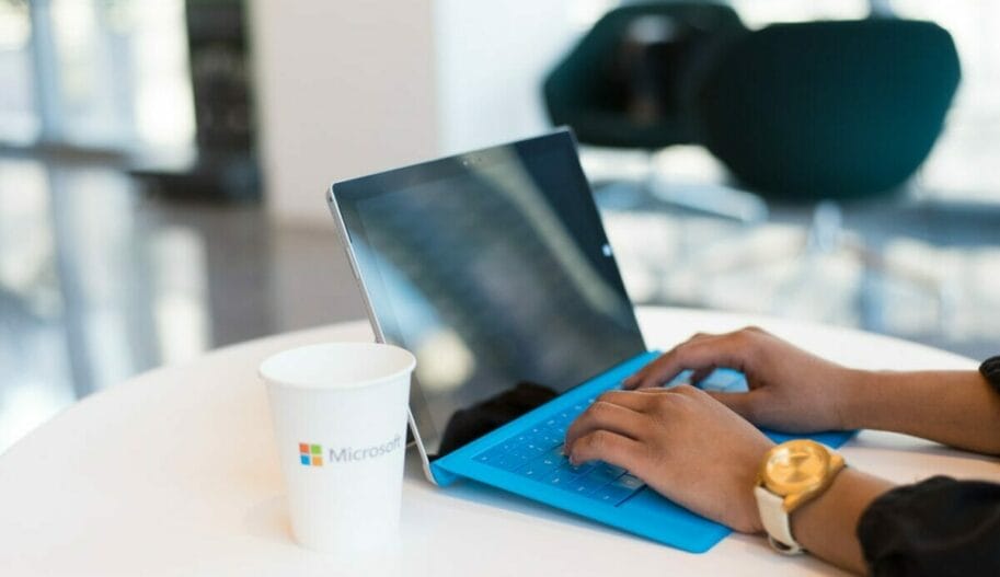 person using blue Microsoft Surface
